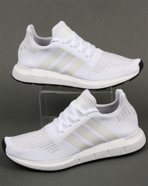 white adidas athletic shoes.